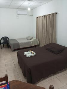 two beds in a room with two beds sidx sidx sidx at Alojamiento Temporario Sol de las Yungas in Libertador General San Martín +13 photos
