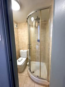 a bathroom with a shower and a toilet at London Collection - Bayswater in London