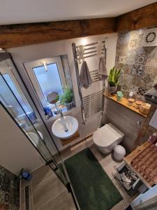 a bathroom with a sink and a toilet and a mirror at Apartment Emilia in Świdnica