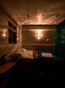 a bedroom with a bed with a light on it at Hidden Monkey Stays Darjeeling, Batasia in Darjeeling +84 photos