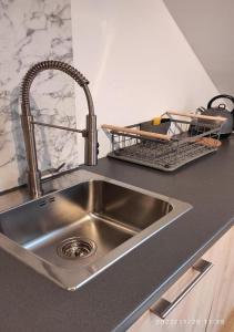 a kitchen counter with a sink and a metal sink at Ferienhaus am Bach im Bayerischen Wald in Achslach +54 photos