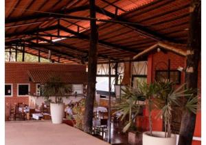 a pavilion with tables and plants in a building at Chale ITU -Camping Carrion - Tomorrowland in Itu