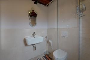 a bathroom with a sink and a toilet at Family Friendly Rosa House Amazing View - Happy Rentals in Barga