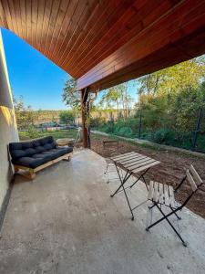 a patio with a couch and a table and chairs at Topaz Villa in Paleu