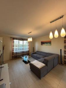 a living room with a couch and a table at Topaz Villa in Paleu