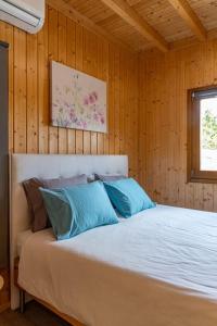 a bedroom with a bed with wooden walls and a window at Porto Maia Garden in Maia +29 photos