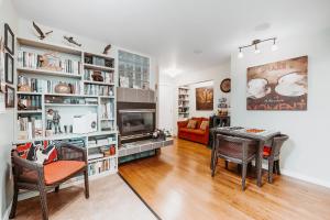 a living room with a table and chairs and a fireplace at Along River Ridge in Calgary