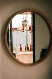 a mirror reflection of a sink and a window at Beach Front Oasis - Catlins, Jacks Bay in Hinahina +20 photos