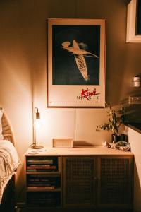 a bedroom with a picture of a bird on the wall at Beach Front Oasis - Catlins, Jacks Bay in Hinahina