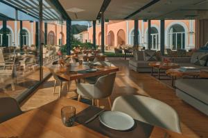 a restaurant with wooden tables and chairs and tables and chairs at Penha Longa Resort in Sintra