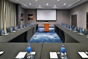 a conference room with tables and bottles of water at Courtyard by Marriott Wilmington Downtown/Historic District in Wilmington +69 photos