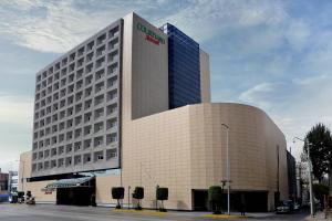 a building with a sign on the side of it at Courtyard by Marriott Mexico City Revolucion in Mexico City