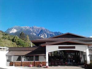 a building with a mountain in the background at Nabalu Kundasang in Kampong Kundassan