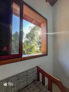 a window in a room with a stair case at Casa espaçosa Ilhabela perto da praia das Conchas in Ilhabela +38 photos