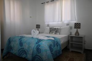 a bedroom with a bed with a stuffed animal on it at Aparta-Hotel Villa Baya in Bayahibe +27 photos
