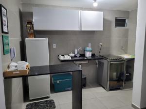 a kitchen with a counter top and a refrigerator at CONDOMÍNIO BOSQUE IMPERIAL ll in João Pessoa