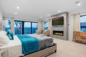 a bedroom with a bed and a fireplace at Guadalupe Bluff Modern House in Kerrville +80 photos