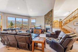 a living room with leather furniture and a fireplace at Highlands Ridge Retreat Massive 9 BDR Estate in Breckenridge