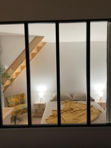 a bedroom with a bed and a loft at Les Charmes de Villers in Huchenneville