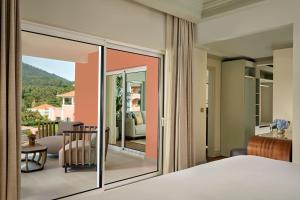 a bedroom with a view of a balcony at Penha Longa Resort in Sintra