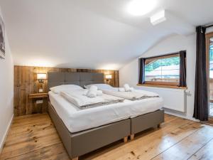 a bedroom with a large bed and a window at Alte Mühle in Hopfgarten im Brixental