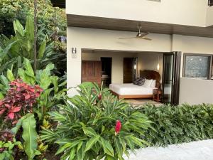a bedroom in a villa with a bed at RESOL Secluded Ocean-view luxury in the Jungle in Uvita