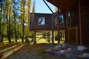 a house in the middle of a forest at Casa Bahía Patagonia in Bahía Murta