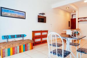 a kitchen with a table and chairs in a room at Flats Paz in Itacaré +19 photos