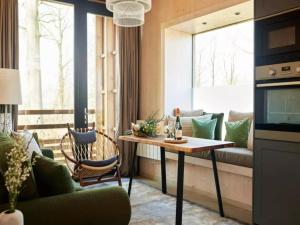a living room with a table and a couch at Forest View Escape for Two in Antoing