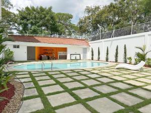 a swimming pool in the backyard of a house at Maca hotel cali in Cali