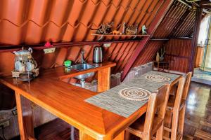 a wooden table in a room with a kitchen at darwin's temple 2 in San Cristóbal