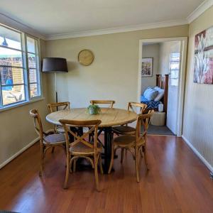 a dining room with a table and chairs at Cupie's Cabin in Talbingo +7 photos