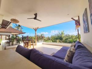 a living room with a large purple couch at Exquisite luxury Villa Candidasa in Candidasa
