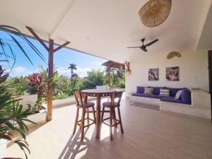 a living room with a table and chairs and a couch at Exquisite luxury Villa Candidasa in Candidasa