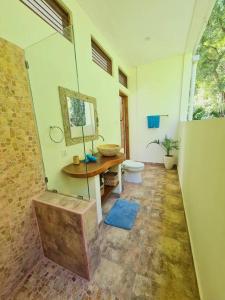a bathroom with a shower with a toilet and a table at Exquisite luxury Villa Candidasa in Candidasa +27 photos