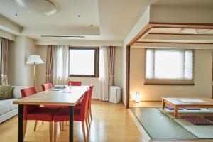 a living room with a table and chairs and a couch at Tokyu Vacations Kyoto in Kyoto