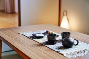 a table with two cups and a plate of food at Tokyu Vacations Kyoto in Kyoto