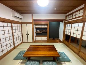a room with a table in the middle of it at 徳治郎の宿 in Izumi-Sano