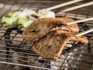 two pieces of meat sitting on a grill at 瀧乃元 近藤家（Kondoke-Inn) in Toon