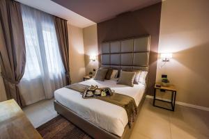 Postel nebo postele na pokoji v ubytování Delle Vittorie Luxury Rooms&Suites