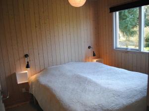 a bedroom with a white bed and a window at Nice Home In Farsø W- in Farsø