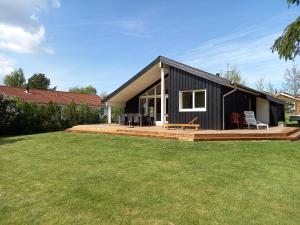 a black house with a large yard at Nice Home In Farsø W- in Farsø