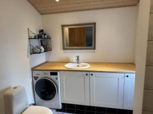 a bathroom with a sink and a washing machine at Beautiful Home In Slagelse With 3 Bedrooms, Internet And Sauna in Slagelse +30 photos