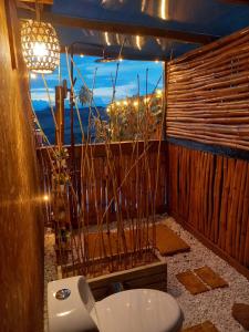 a bathroom with a toilet in front of a window at Tacuara House in San Gil +40 photos