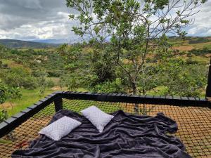 a blanket laying on a table with a view at Tacuara House in San Gil