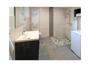 a bathroom with a sink and a shower at Holiday apartment Möwenblick in Norden