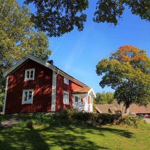 a red house sitting on top of a lush green field at Nice Home In Värnamo With 2 Bedrooms And Wifi in Värnamo
