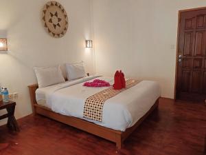 Un dormitorio con una cama con una bolsa roja. en Gili Air Santay Bungalows, en Gili Air 23 fotos más