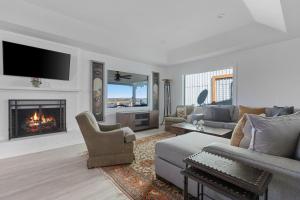 a living room with a couch and a fireplace at Guadalupe Bluff Farmhouse in Kerrville