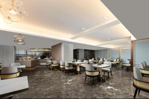 a restaurant with tables and chairs and a bar at Atour Hotel Haikou Wanguo Metropolis Qilou Old Street in Haikou
